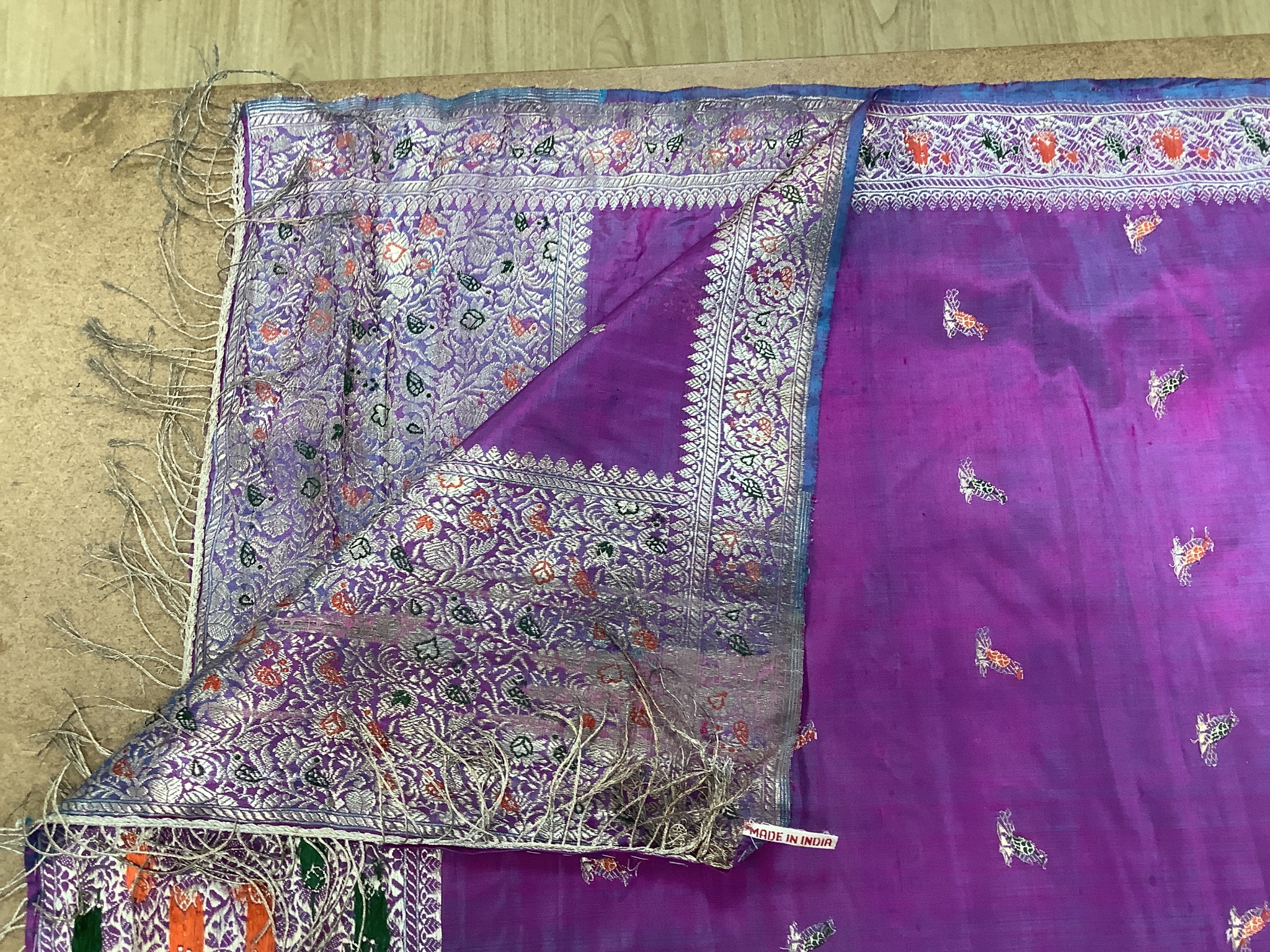 A Chinese embroidered silk panel of a phoenix, 84.5 x 54 cm, an Indian silk panel and a metal beadwork purse